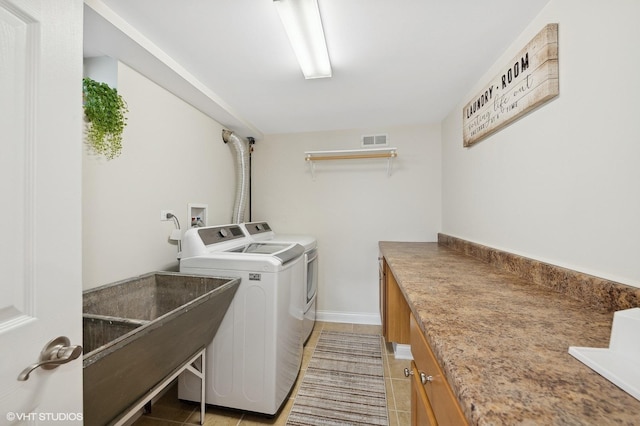 laundry area with tile patterned flooring and separate washer and dryer