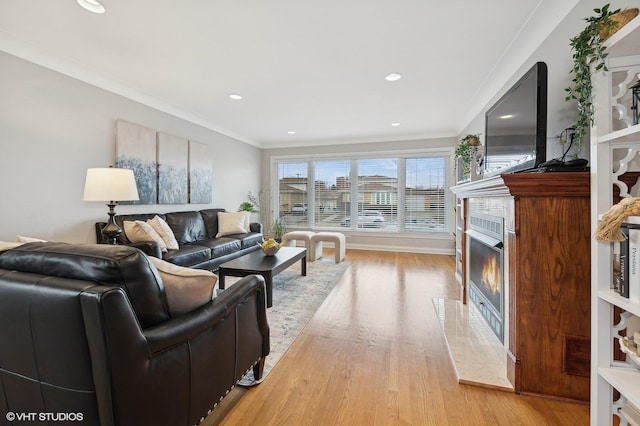 living room featuring ornamental molding and light hardwood / wood-style floors