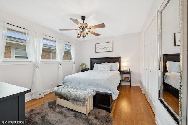 bedroom with hardwood / wood-style flooring, ceiling fan, and a closet