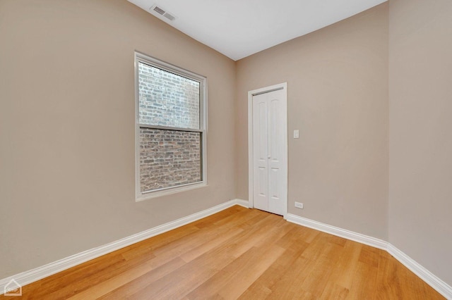 unfurnished room featuring hardwood / wood-style flooring