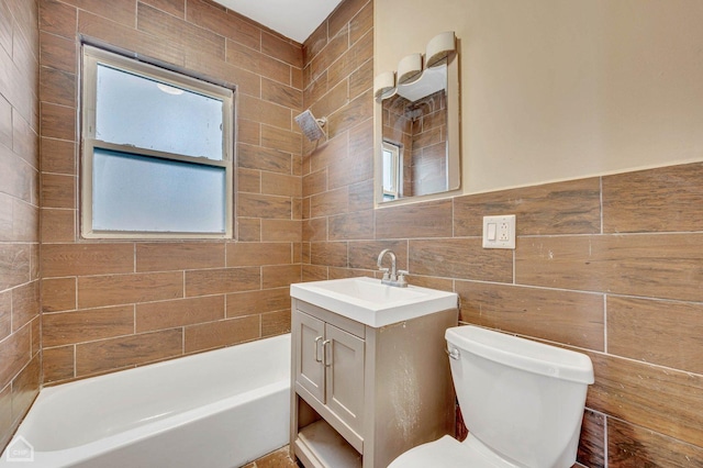 full bathroom featuring vanity, toilet, plenty of natural light, and tile walls