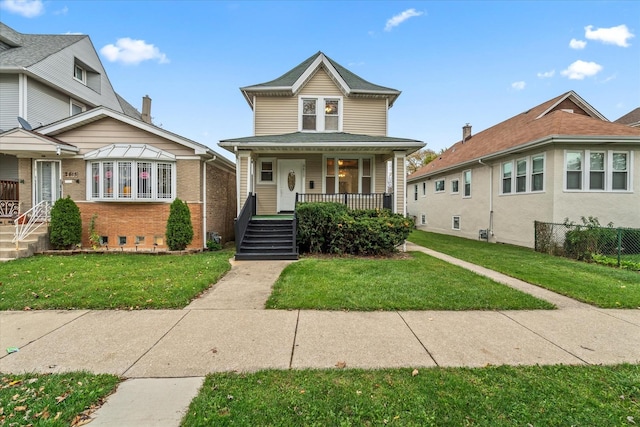 view of front of property with covered porch and a front yard