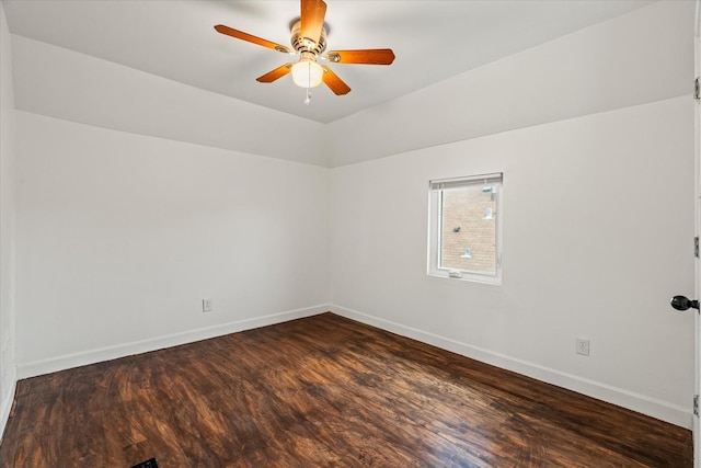 spare room with ceiling fan and dark wood-type flooring