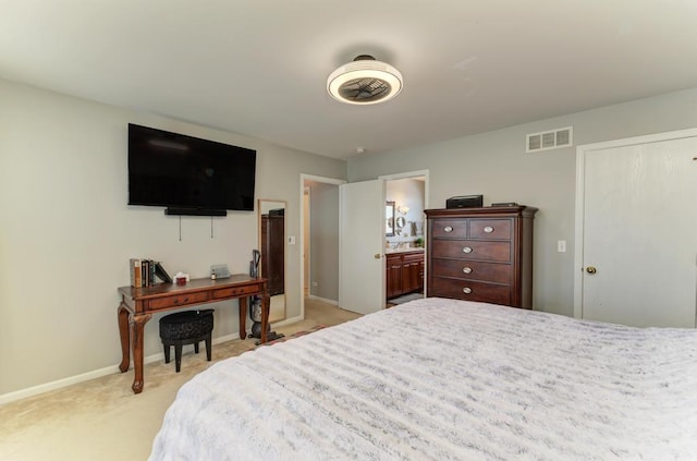 carpeted bedroom featuring ensuite bathroom