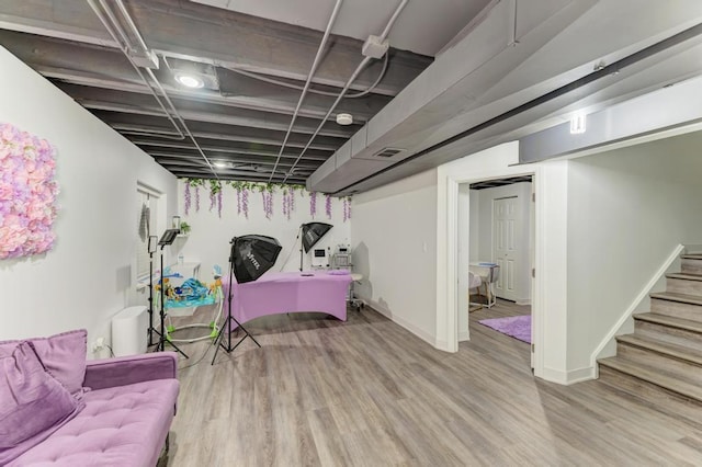 basement with light hardwood / wood-style floors