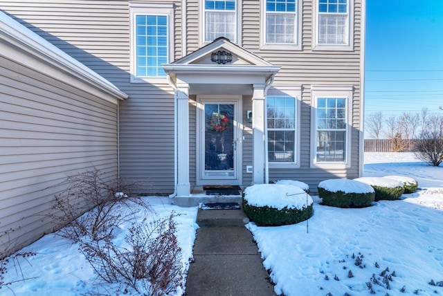 view of snow covered property entrance