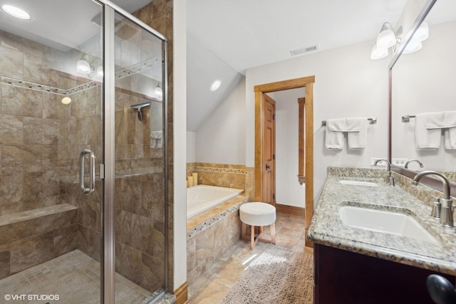 bathroom with vanity, lofted ceiling, and independent shower and bath