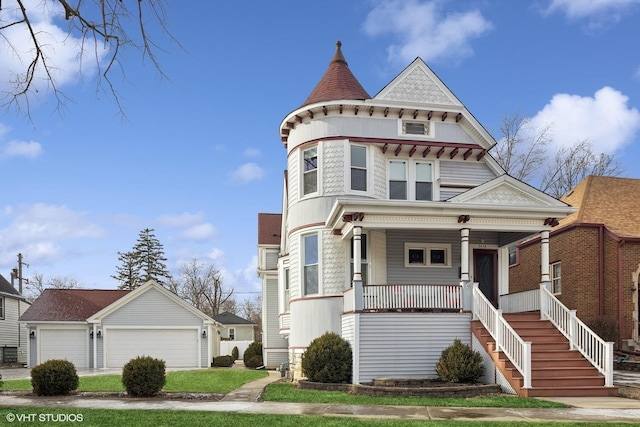 victorian home with a porch and a garage