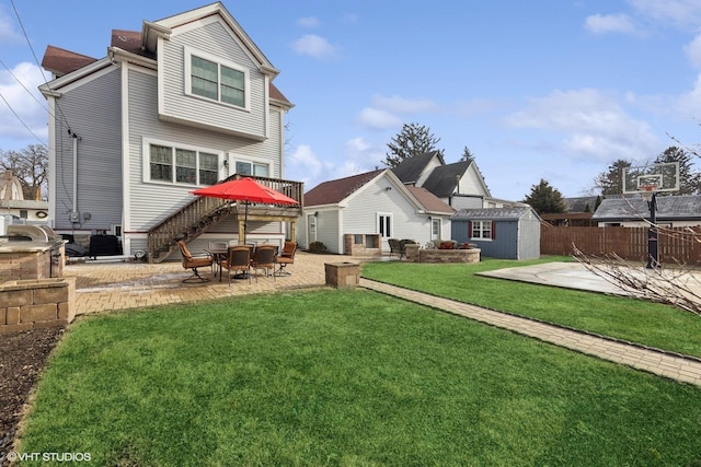 rear view of house featuring a storage unit, central air condition unit, a patio area, and a lawn