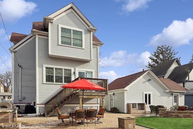 rear view of property featuring a patio