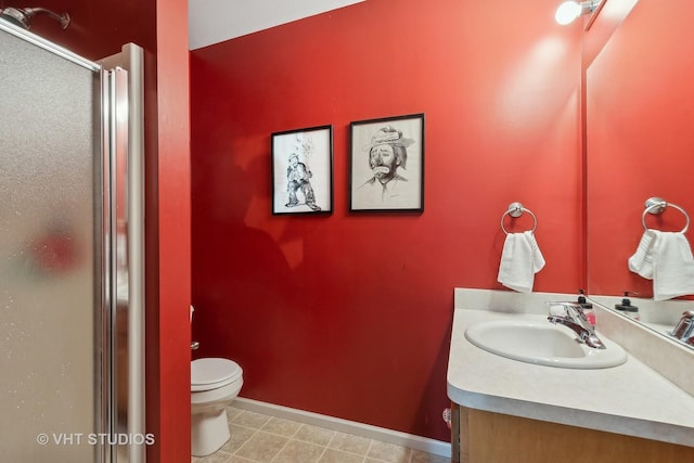 bathroom featuring an enclosed shower, vanity, and toilet