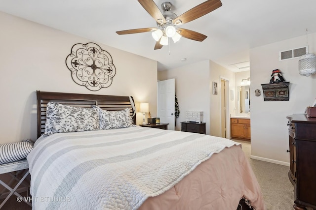 carpeted bedroom with ceiling fan and ensuite bathroom