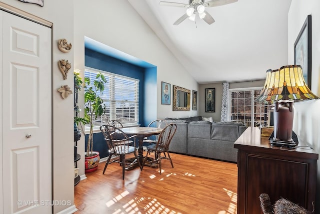 dining space with light hardwood / wood-style floors, lofted ceiling, and ceiling fan