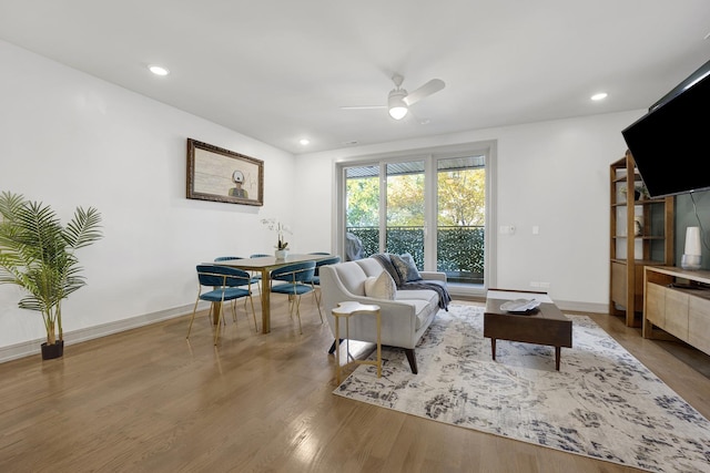 living room featuring hardwood / wood-style flooring and ceiling fan