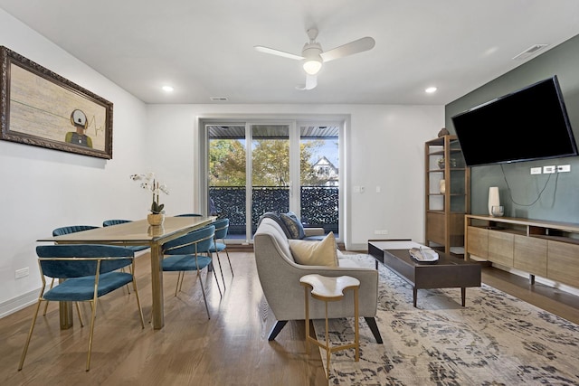 living room with ceiling fan and wood-type flooring