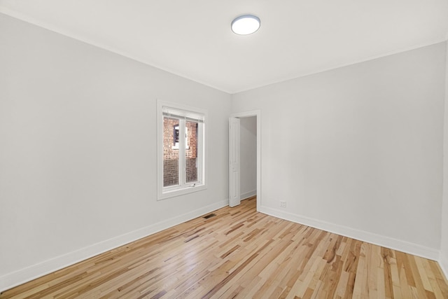 spare room with light hardwood / wood-style flooring