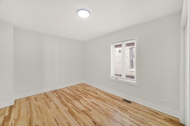 spare room featuring light wood-type flooring