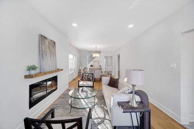 living room featuring wood-type flooring and a chandelier