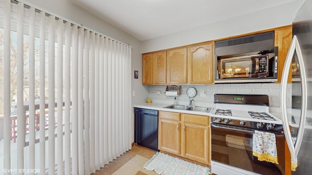 kitchen featuring dishwasher, sink, decorative backsplash, white gas range, and light tile patterned flooring