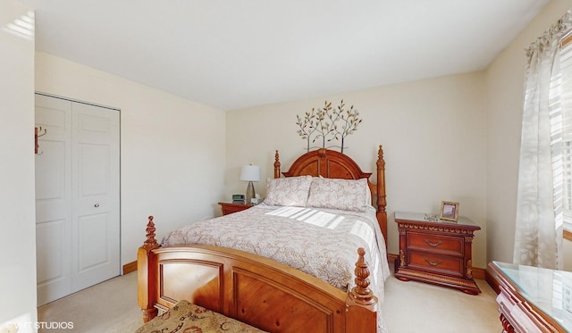 bedroom featuring light carpet and a closet