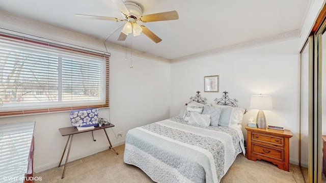 carpeted bedroom featuring a closet and ceiling fan