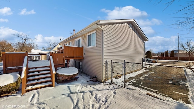 view of snow covered exterior featuring a deck