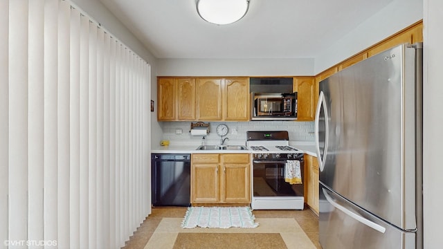 kitchen featuring sink, backsplash, and appliances with stainless steel finishes