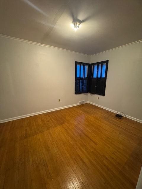 unfurnished room with hardwood / wood-style floors and ornamental molding