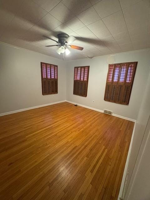 spare room featuring hardwood / wood-style floors and ceiling fan