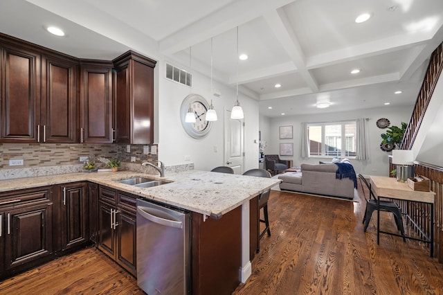 kitchen with pendant lighting, dishwasher, a kitchen bar, dark wood-type flooring, and sink