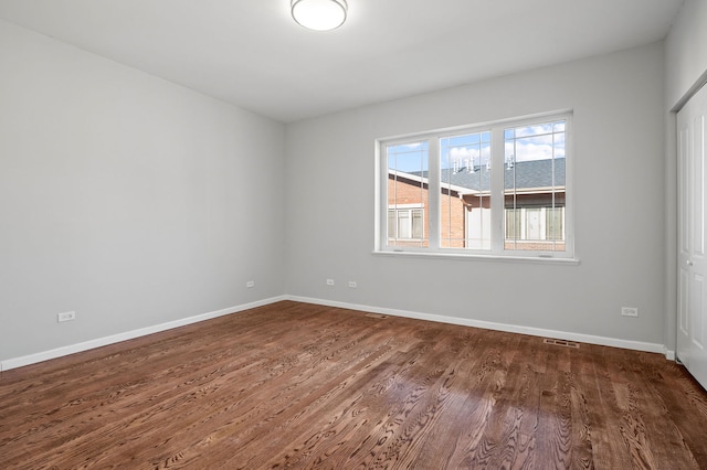 spare room with wood-type flooring