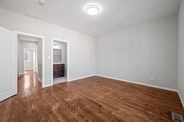 unfurnished room with wood-type flooring