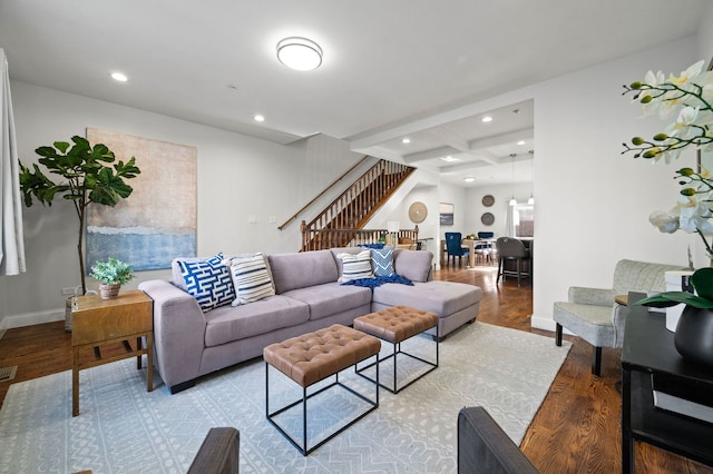 living room featuring coffered ceiling, light wood-type flooring, and beam ceiling