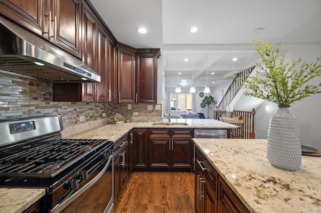 kitchen with sink, backsplash, light stone countertops, dark hardwood / wood-style floors, and stainless steel appliances