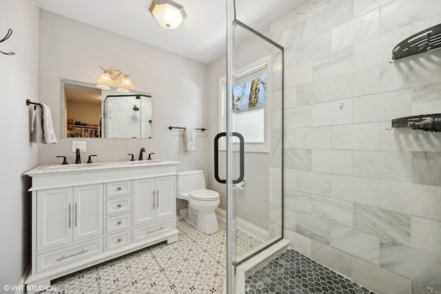 bathroom with toilet, walk in shower, and vanity