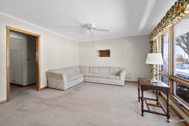 carpeted living room featuring ornamental molding and ceiling fan