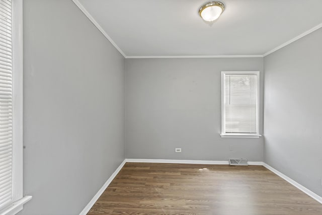 spare room featuring hardwood / wood-style floors and ornamental molding