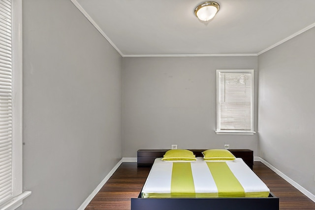 bedroom featuring dark hardwood / wood-style flooring and ornamental molding