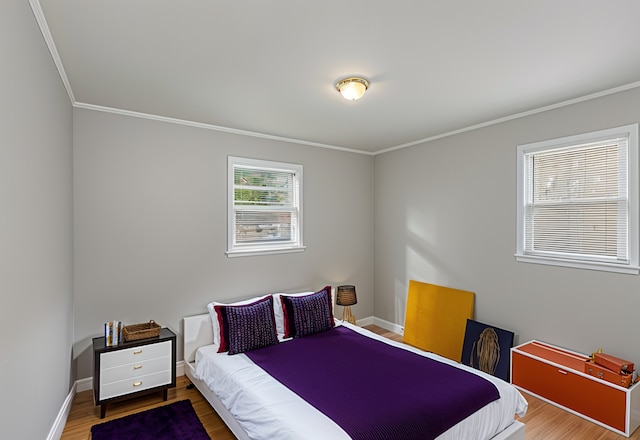 bedroom featuring wood-type flooring and ornamental molding