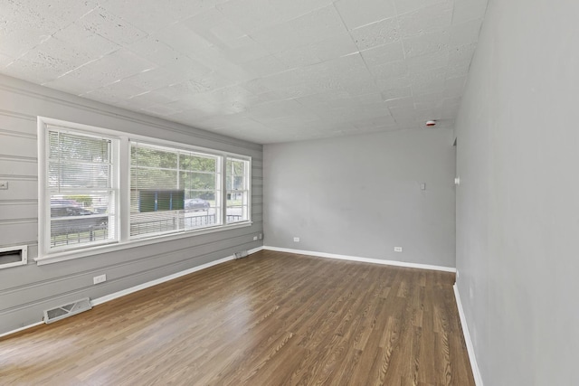 unfurnished room with wood-type flooring