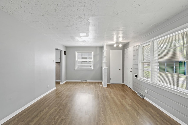 unfurnished room with hardwood / wood-style floors