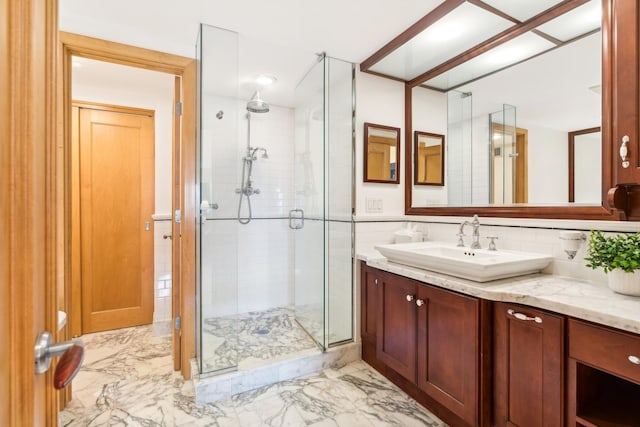 bathroom featuring an enclosed shower and vanity