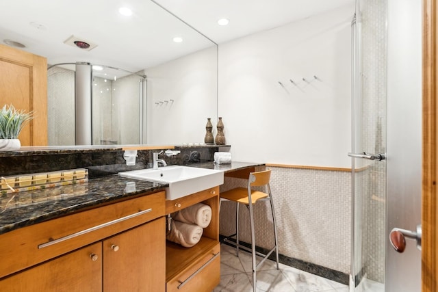 bathroom featuring vanity, tile patterned floors, and walk in shower