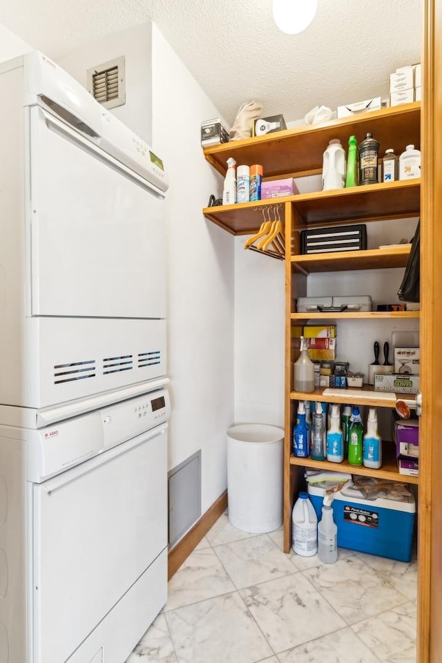 pantry with stacked washer / drying machine