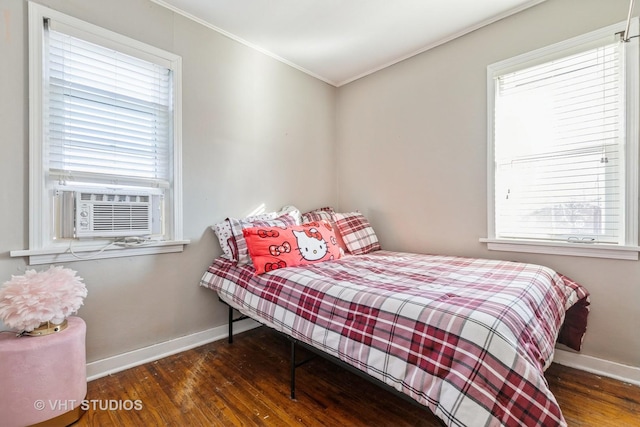 bedroom with dark wood-type flooring, crown molding, and cooling unit