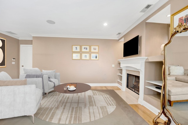 living room featuring light hardwood / wood-style floors and crown molding