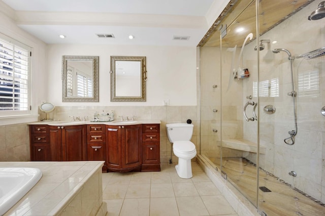 full bathroom with plus walk in shower, vanity, tile patterned floors, and toilet