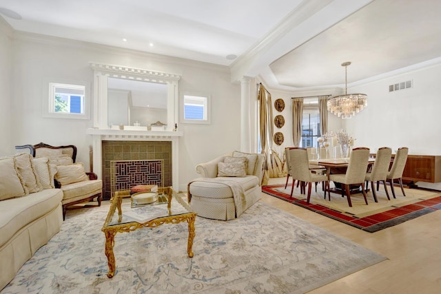 sitting room with hardwood / wood-style floors, a healthy amount of sunlight, and a fireplace