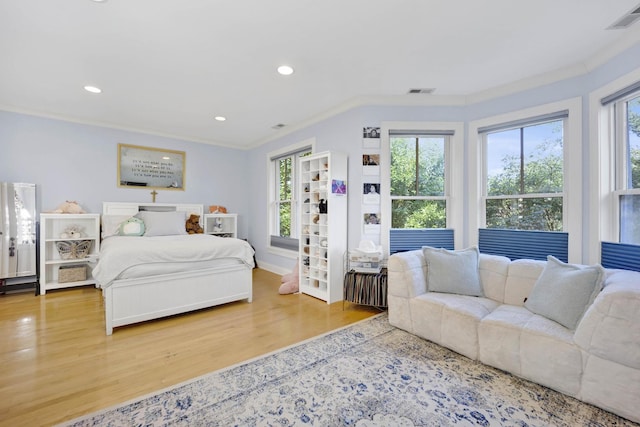 bedroom with crown molding and hardwood / wood-style floors