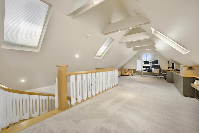 bonus room with light colored carpet and lofted ceiling with skylight